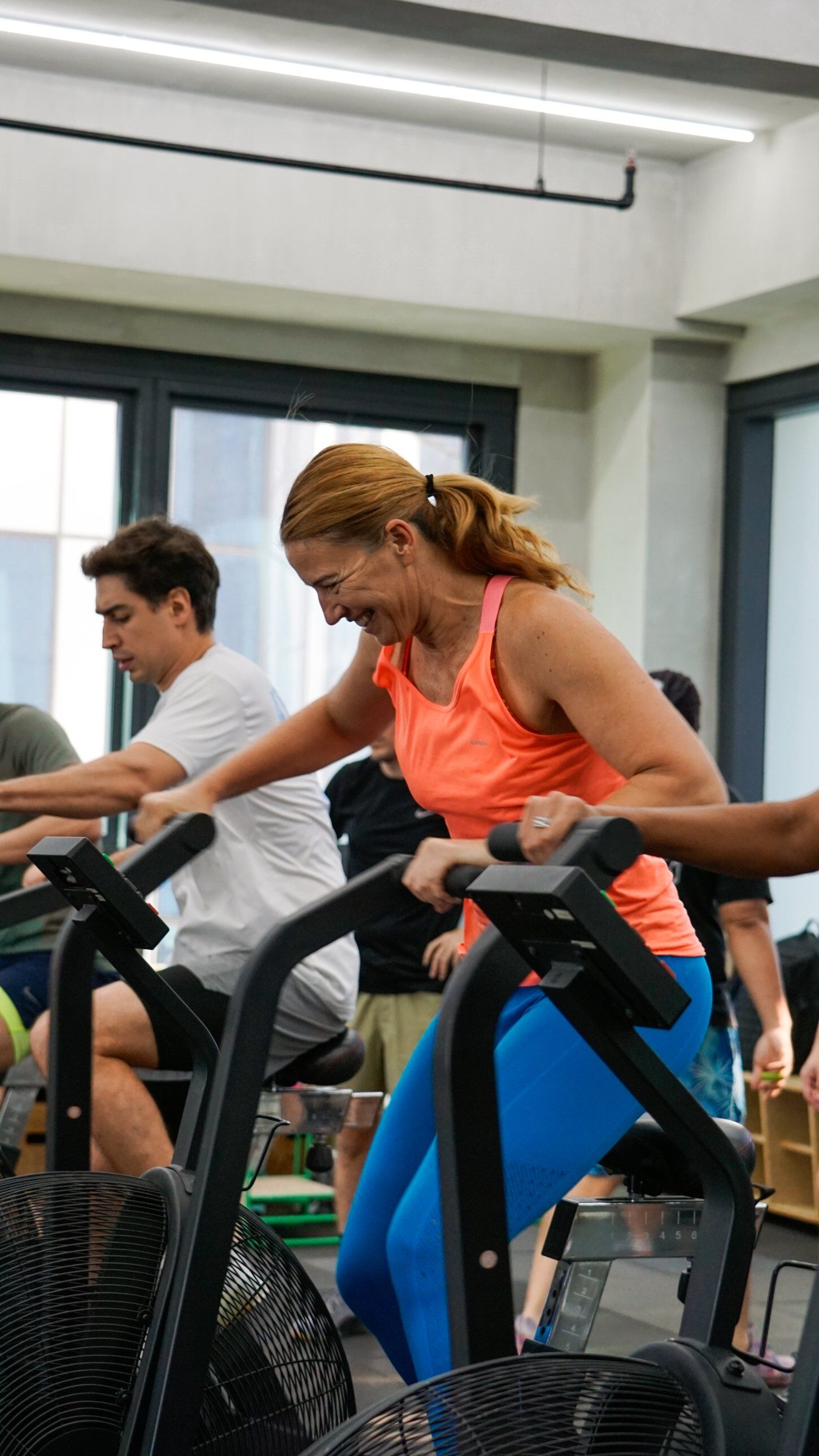 Members on air bikes during a coached FAST session
